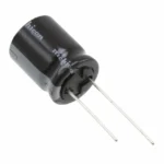 Black Nichicon electrolytic capacitor with metal leads, used in electronic circuits for energy storage or filtering.