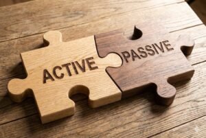 Wooden puzzle pieces with the words 'Active' and 'Passive' on a wooden table.