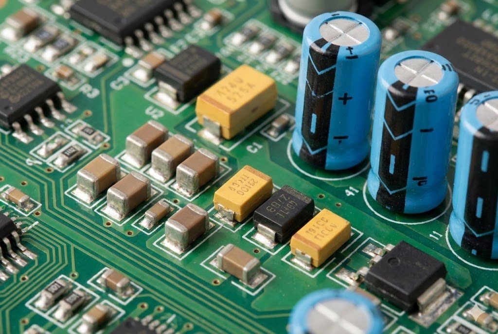 Capacitor Types Selection alt text: A collection of ceramic, electrolytic, and tantalum capacitors on a circuit board