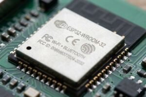 Close-up of ESP32-WROOM-32 module with WiFi and Bluetooth features for IoT on a circuit board.