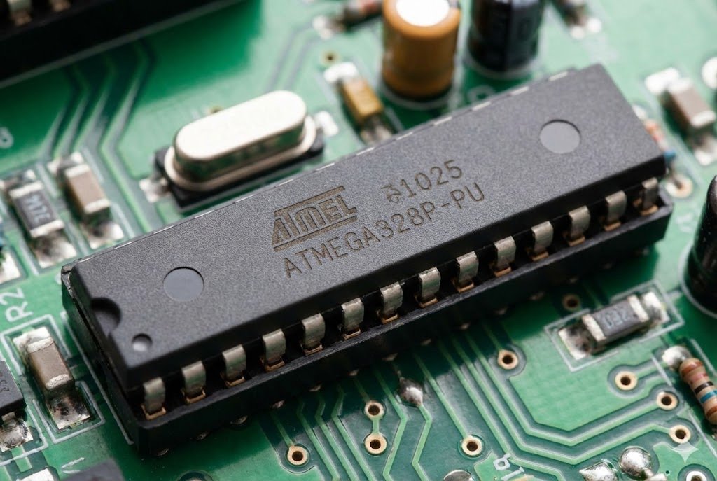 Original ATMEGA Microcontrollers A close-up of an ATMEGA microcontroller chip on a circuit board